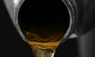 Engine oil pouring from canister, closeup